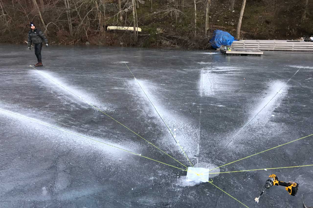 Grooves for LED tape being measured out in lake ice