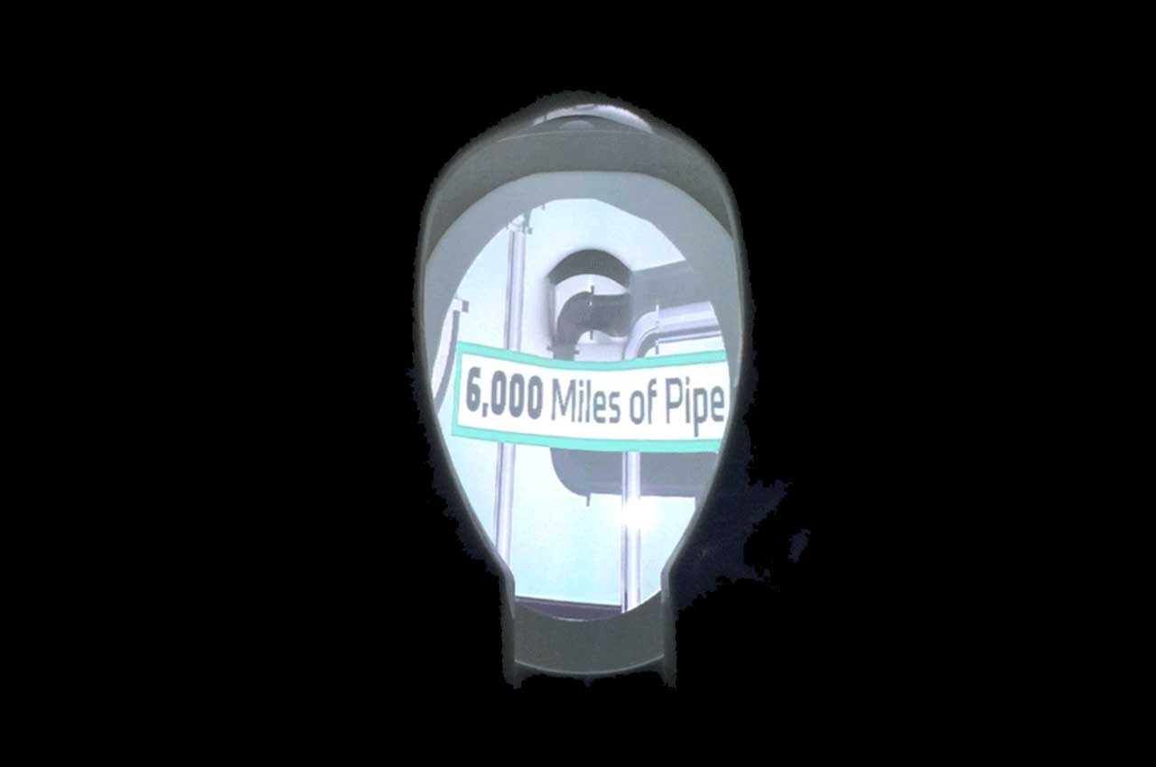 Projection of the words '6,000 miles of pipe' in a toilet