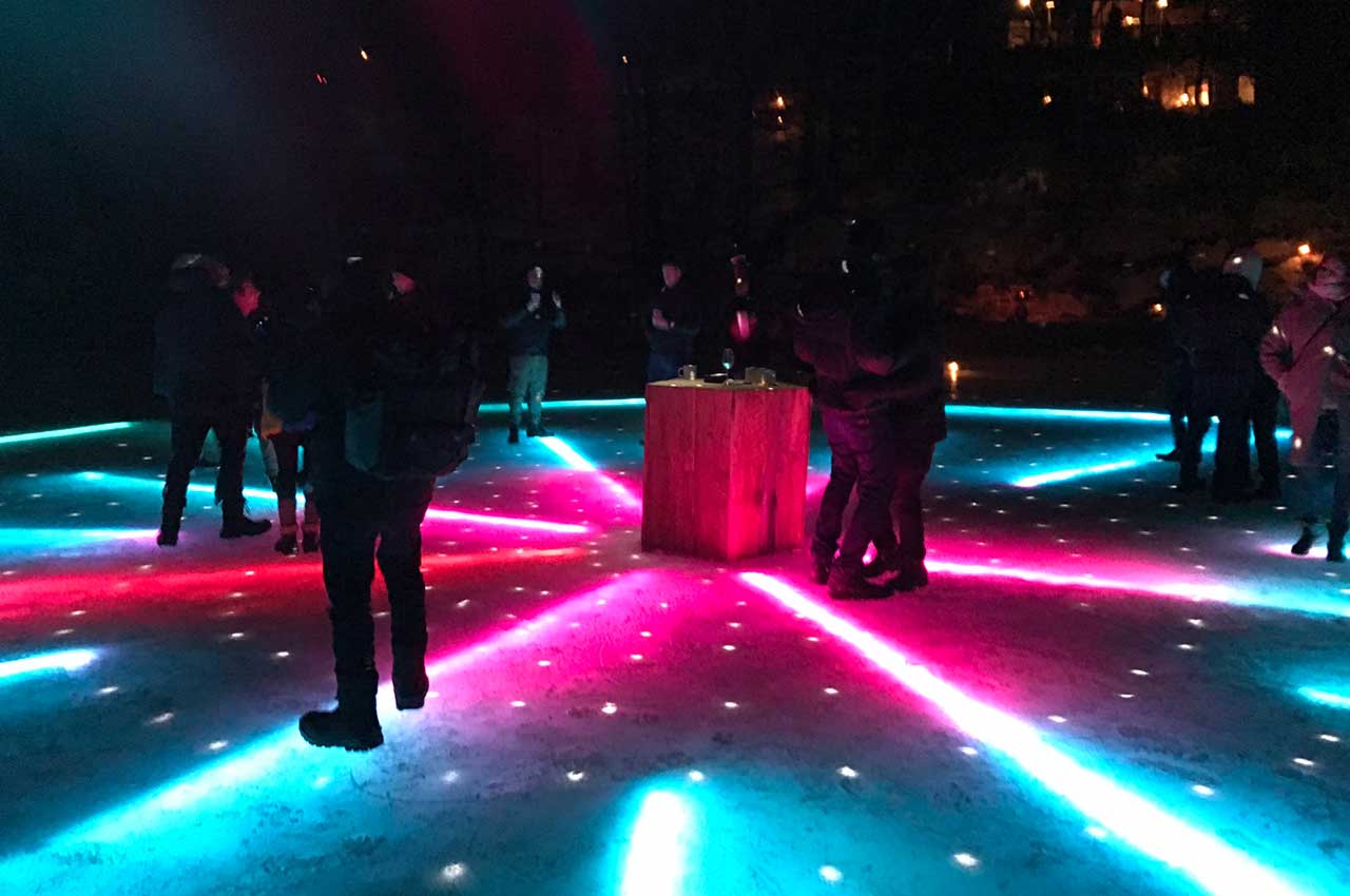 Installed LED dancefloor in ice turned on and with people on it